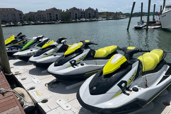 a row of parked motorcycles sitting on top of a boat