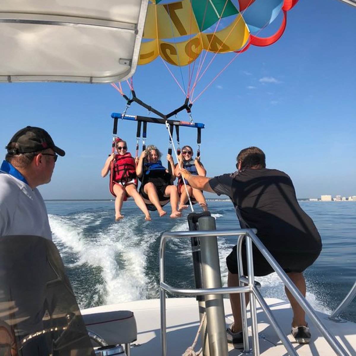 Three ladies launching in a parasail