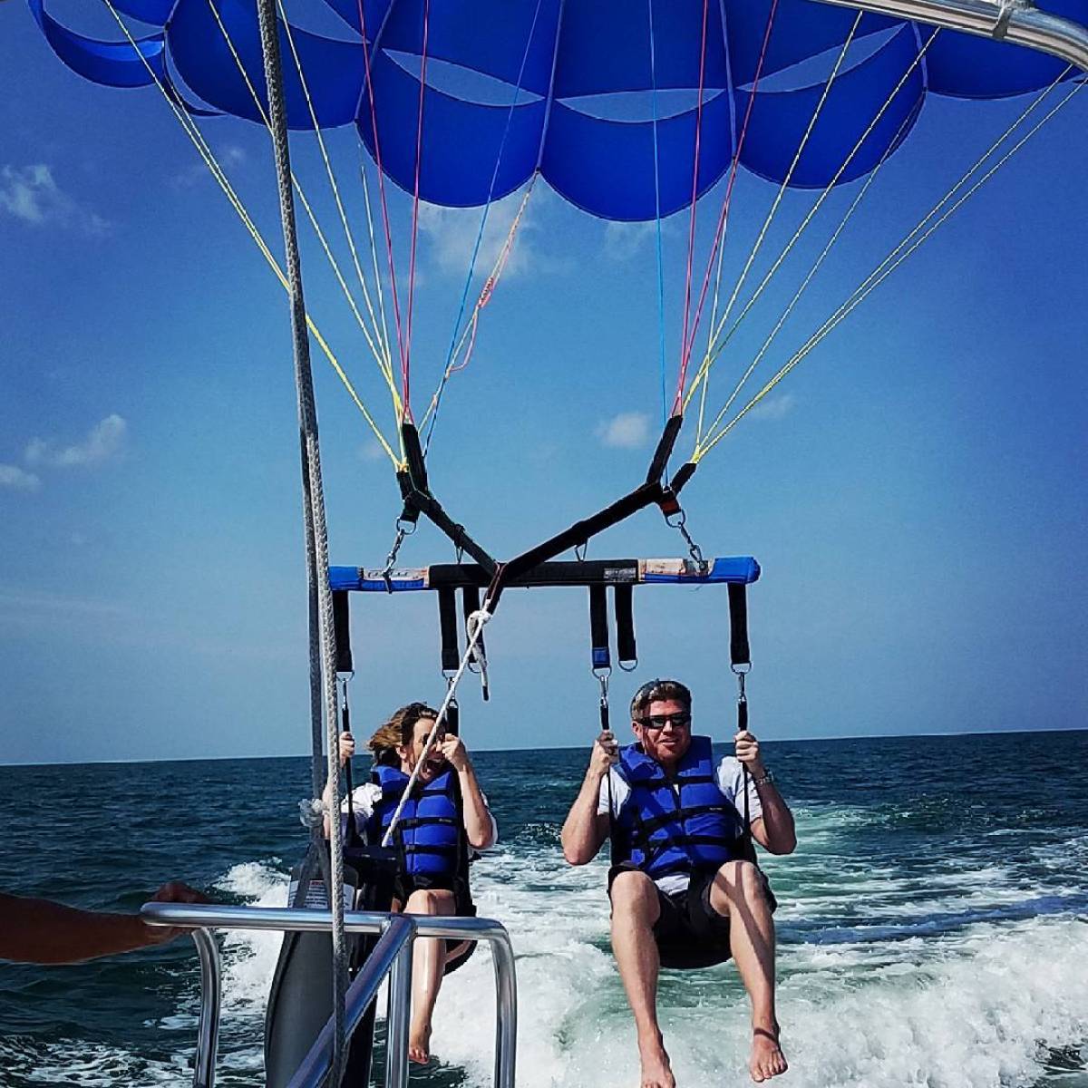 A couple getting ready for launch on a parasail