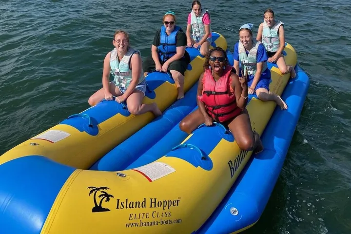 a group of people in a boat on a body of water