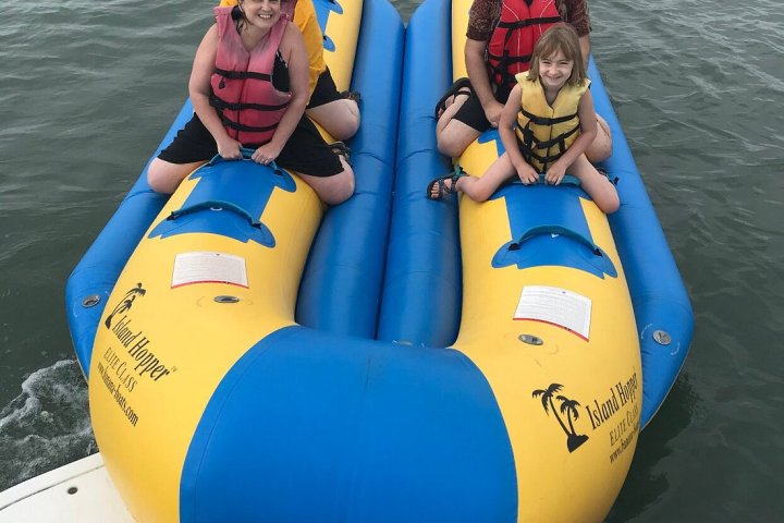 a group of people on a raft in a body of water