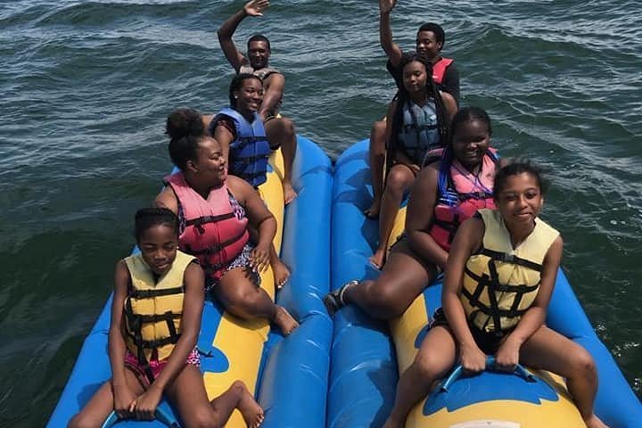 a group of people on a raft in a body of water