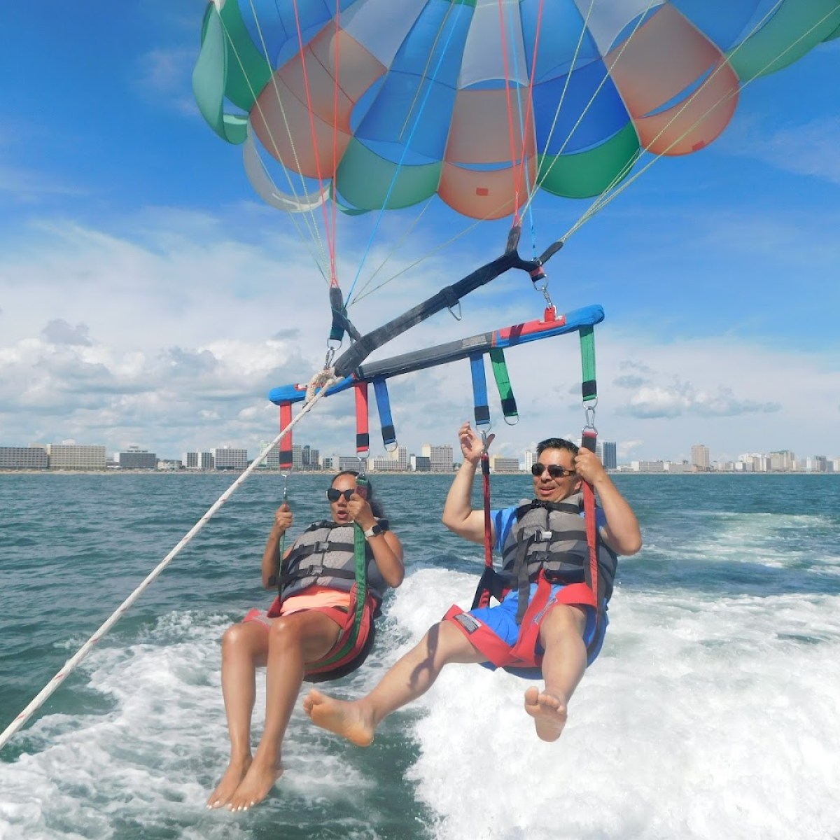 a group of people riding on the back of a boat in the water